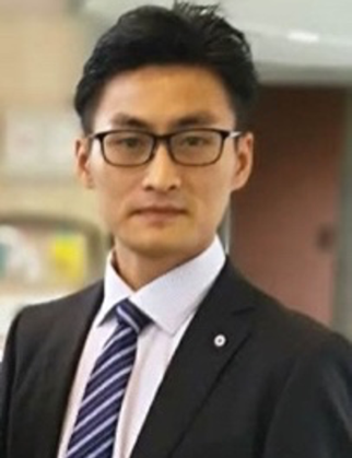 A person wearing glasses and a suitDescription automatically generated with medium confidence